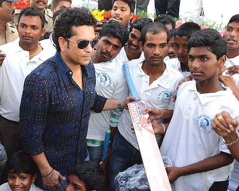 Sachin Tendulkar distributing cricket kits to students at PR Kandriga village on Wednesday | Express photo