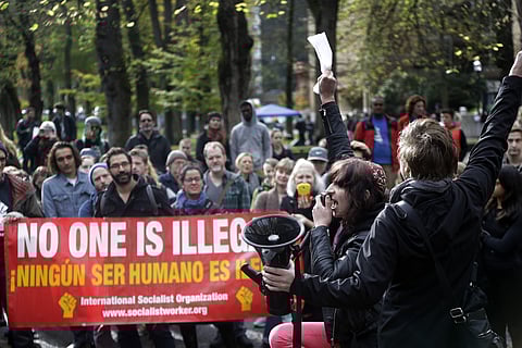 Protester Phoenix Singer, second from right, leads a chant before he and others march through the streets in Portland, Ore., Wednesday, Nov. 16, 2016. | AP