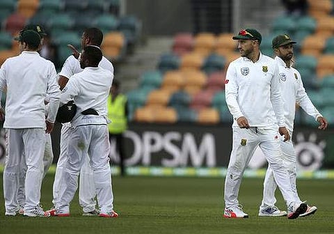 South Africa's Faf du Plessis, second right, and Jean-Paul Duminy, right, lead their team off at the end of play against Australia during their cricket test match in Hobart.(Photo | AP)