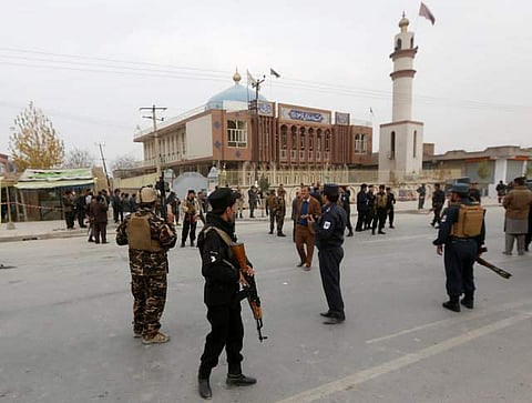 Afghan security forces keep watch in front of the mosque where an explosion happened on Monday. (Photo | Reuters)