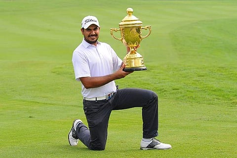 Gaganjeet Bhullar of India poses with the trophy after winning the Bank BRI - JCB Indonesia Open 2016 at Pondok Indah golf course in Jakarta. | AFP