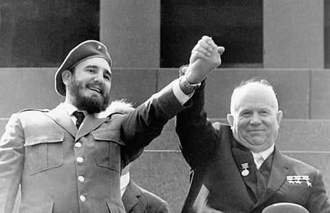 In this May 1, 1963 file photo, Cuba's leader Fidel Castro, left, and Soviet Premier Nikita Khrushchev clasp hands at the Lenin mausoleum in Moscow's Red Square on May Day in Moscow, Russia. | AP