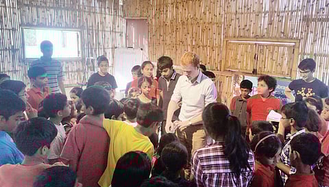 Sam (in white shirt) and Louis (in black t-shirt) conducting the workshop