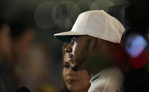 Mercedes driver Lewis Hamilton of Britain speaks with the media in the pit area.(Photo| AP)