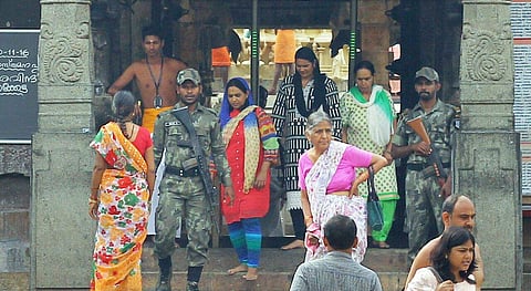 A protestor sends back two women who attempted to enter the Padmanabha Swamy Temple in churidars on Wednesday. |(Kaviyoor Santhosh | EPS)