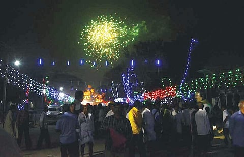 Tourists enjoying the fireworks display part of the Hampi Utsav on Friday | D Hemanth