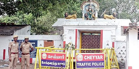 Policemen stand guard outside the sealed Thulukanathamman Temple in Tamil Nadu