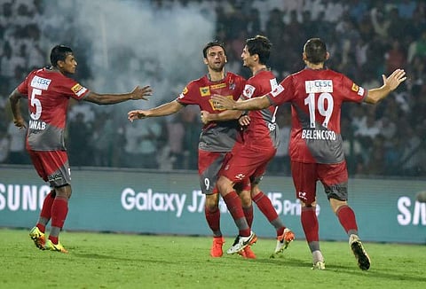 Atletico de Kolkata’s forward Helder Manuel Marques Postiga (2L) celebrates with his teammates after scoring a goal during the Indian Super League (ISL) football match. | AFP