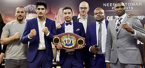 Indian boxing star Vijender Singh 2ndL and Francis Cheka R current intercontinental Champion with Neerav Tomar C MD IOS Boxing Promotions and others during a conference ahead of their fight. | PTI