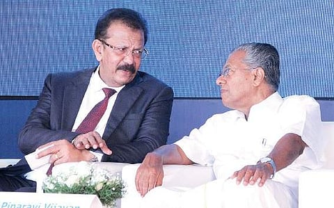 Chief Minister Pinarayi Vijayan interacts with V K Mathews, founder and executive chairman of IBS Software, after unveiling the foundation stone for the new campus of IBS at Infopark in Kochi on Monda