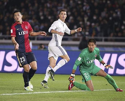 Real Madrid's Cristiano Ronaldo, center, looks at the ball with Kashima Antlers' Naomichi Ueda, left, and goalkeeper Hitoshi Sogahata after scoring his second goal in the overtime.(Photo | AP)