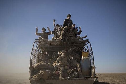 Popular Mobilization Units fighters ride on the back of a truck on their way to fight against Islamic State militants in the airport of Tal Afar, west of Mosul, Iraq.(AP)