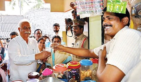 Union minister P Ashok Gajapathi Raju buying a water bottle from a shop at his adopted village, Dwarapudi in Vizianagaram dist on Monday | Express