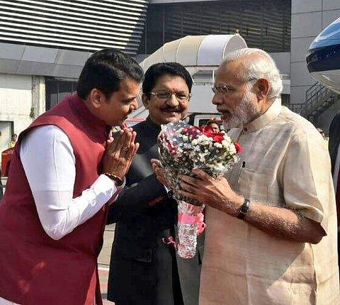 Maharashtra CM Devendra Fadnavis (L), and Governor Vidyasagar Rao (C) receive PM Modi (R) in Mumbai. | Express Photo Service