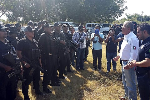 Javier Olea, attorney general of Guerrero state, right, talks to police at the start of a security operation in San Jeronimo El Grande, Mexico, Thursday, Nov. 24, 2016. | AP