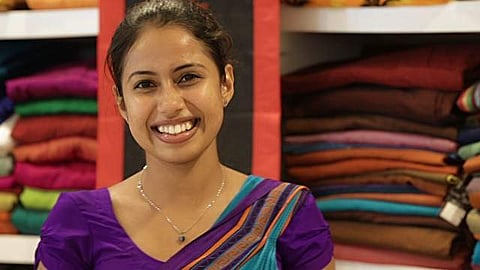 Sri Lankan woman in the now sanctioned sari and a blouse with sleeves.