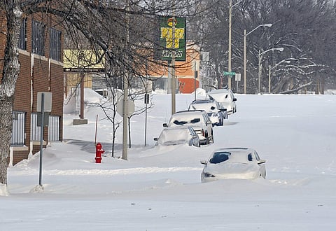 Bismarck's Second Street in the downtown area had cars stuck in snowdrifts Monday, Dec. 26, 2016, in Bismarck, N.D.| AP