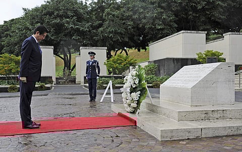 Japanese Prime Minister Shinzo Abe visits the National Memorial Cemetery of the Pacific to place a wreath at the Honolulu Memorial, Monday, Dec. 26, 2016, in Honolulu.