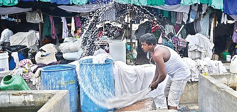 A dhobi washing hospital linen at the Chetpet dhobi khana, Chennai, on Wednesday. Linen bearing tags of several major hospitals in the city were seen at the location | ASHWIN PRASANTH