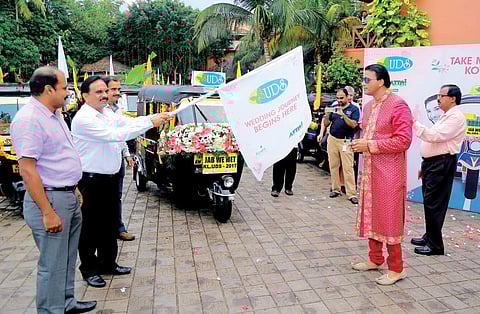 Tourism Director U V Jose flagging off the fleet of autorickshaws which were part of the marriage procession at Kovalam Express