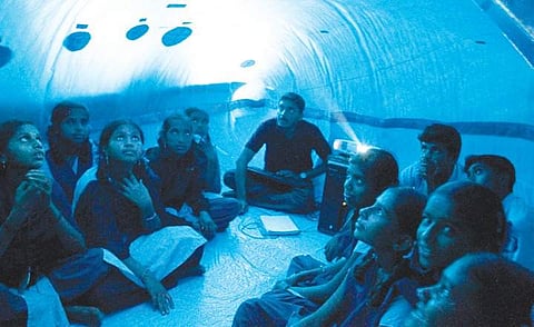 Prajwal (centre) at a school