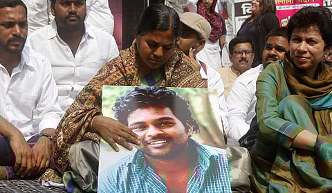 University Dalit scholar Rohith Vemula's mother Radhika Vemula holding her son's portrait during a Youth Congress protest. (File|EPS)