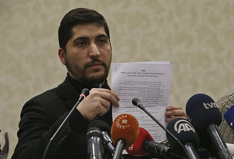 Osama Abu Zeid of the the main moderate Syrian opposition group Free Syrian Army, shows what he said is a copy of the five-point cease-fire agreement for Syria. | AP