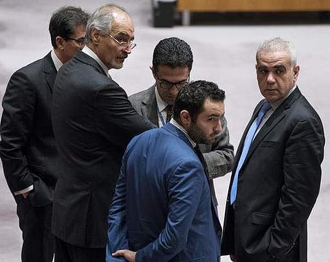 Syria's permanent representative to the United Nations, Bashar Jaafari, second from left, and others pause just before consultations end at the U.N. Security Council at U.N. headquarters on December 18. (File Photo | AP)