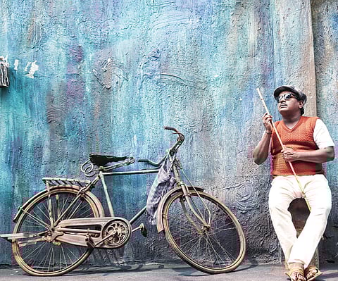 A still from the film Raaga featuring Mitra as a blind man