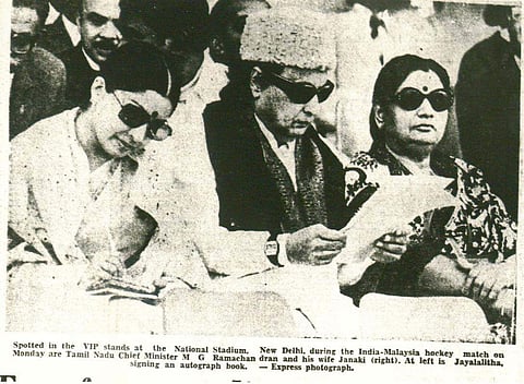 Spotted in the VIP stands at the National Stadium, New Delhi, during the India-Malaysia hockey match are Tamil Nadu Chief minister M G Ramachandran and his wife Janaki Ramachandran (right). At his left is J Jayalalithaa signing an autograph book | Express