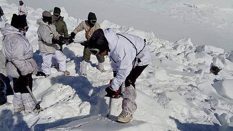 Improving weather allowed a helicopter to reach the base camp Tuesday and rescuers were able to begin shifting through the snow and ice.