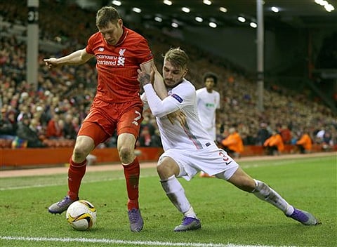Liverpool's James Milner, left, and FC Augsburg's Kostas Stafylidis battle for the ball during the Europa League, round of 32, second leg soccer match between Liverpool and FC Augsburg in Liverpool, England. |AP