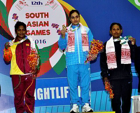 Gold medal winner Harshdeep of India silver medal winner Chamari Mendis Wadumesthreege Warnakula Suriya of Sri Lanka and bronze medal winner Devi Kumari Chaudhry of Nepal on the podium after 53 Kg weightlifting event at the 12th South Asian Games at Tepes