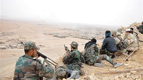 Syrian soldiers take up positions during fighting between Government forces and Islamic State group militants.