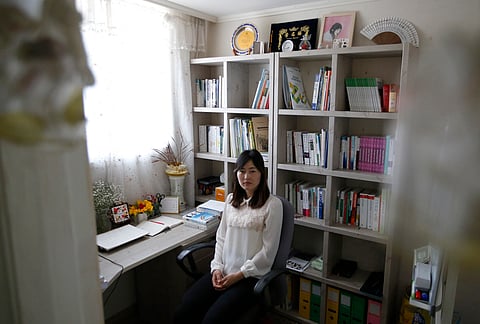 In this March 25, 2016 photo, exiled North Korean Gae-yoon Lee poses for a photo at her home in Seoul, South Korea. Lee, who was raised on a collective farm, left North Korea in 2010 with only a high school diploma. Six years later, she’s a published poet