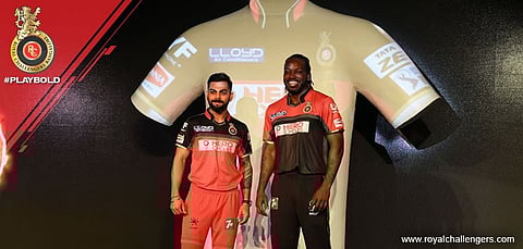 RCB Skipper Virat Kohli and Opener Chris Gayle flaunt the new jerseys, at an event yesterday. | Photo Courtesy Royal Challengers Bangalore Official Facebook Page.