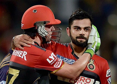 RCB batsman AB de Villiers greets captain Virat Kohli after winning the IPL Match against KKR in Kolkata on Monday. | PTI