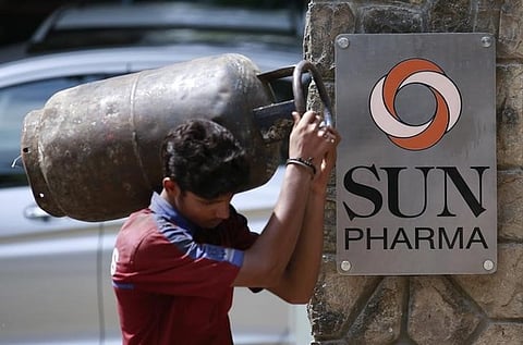 A man carrying a gas cylinder walks out of the research and development centre of Sun Pharmaceutical Industries Ltd in Mumbai | Reuters