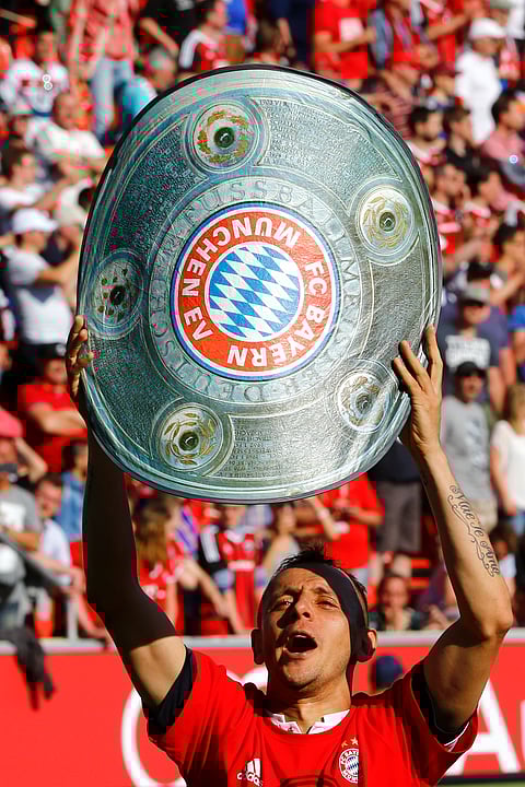 Bayern's Rafinha celebrates with a a mock trophy after winning the 26th Bundesliga title at the German Bundesliga soccer match between FC Ingolstadt and FC Bayern Munich in Ingolstadt, Germany, Saturday, May 7, 2016. | AP