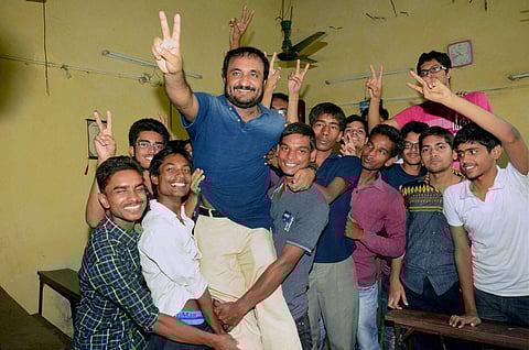 Successful students of 'Super-30' group celebrate with their teacher Anand Kumar the result of IIT JEE Advanced in Patna on Sunday. (PTI)
