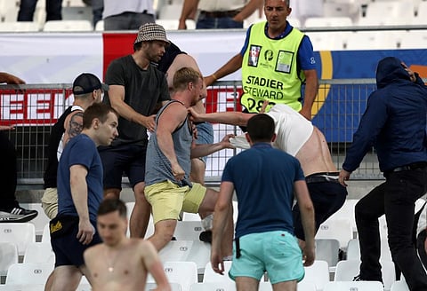 Supporters fight at the end of the Euro 2016 group B football match between England and Russia at the Stade Velodrome in Marseille on June 11, 2016. | AFP