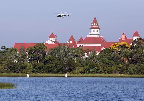 An Orange County Sheriffs helicopter searches for a young boy early Wednesday, June 15, 2016, after the boy was dragged into the water Tuesday night by an alligator near Disney's upscale Grand Floridian Resort & Spa in Lake Buena Vista, Fla. | AP