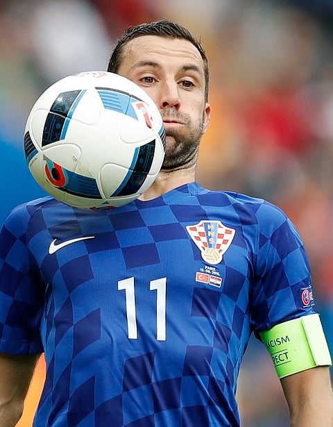 Croatia's Darijo Srna gets the ball on his face, during the Euro 2016 Group D soccer match between Turkey and Croatia at the Parc des Princes stadium in Paris, France, Sunday, June 12, 2016. | AP