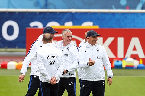 France coach Didier Deschamps, center, and his assistant Guy Stephan, right, smile during a training session at the Clairefontaine training center, outside Paris, France, Sunday, June 12, 2016. | AP