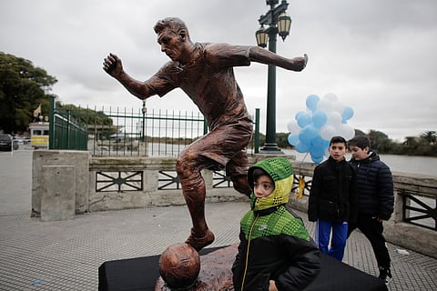Children stand by the statue of soccer star Lionel Messi shortly after it was unveiled in Buenos Aires, Argentina. |AP