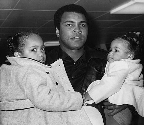 In this Dec. 20, 1978, file photo, World heavyweight champion Muhammad Ali carries his daughters, 2-year-old Hana, left, and nine-month-old Laya at London's Heathrow Airport. (File|AP)