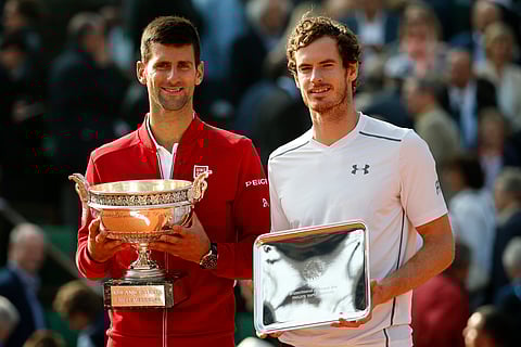 Serbia's Novak Djokovic, left, and Britain's Andy Murray holds their trophy after their final match of the French Open tennis tournament at the Roland Garros stadium in Paris. |AP