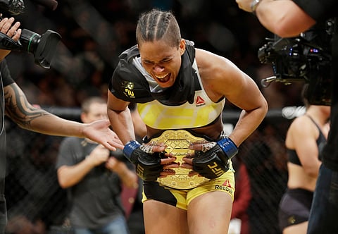 Amanda Nunes celebrates after defeating Miesha Tate during their women's bantamweight championship mixed martial arts bout at UFC 200, Saturday, July 9, 2016, in Las Vegas. | AP