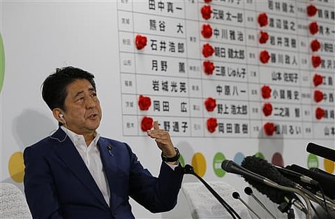Japan's Prime Minister Shinzo Abe, leader of the Liberal Democratic Party, answers a question from reporter during a TV interview in Tokyo. (AP)