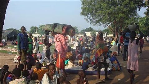 In this image from December 2023, displaced women, men and children gather to seek shelter in Juba, South Sudan at the UN compound in Tomping area.